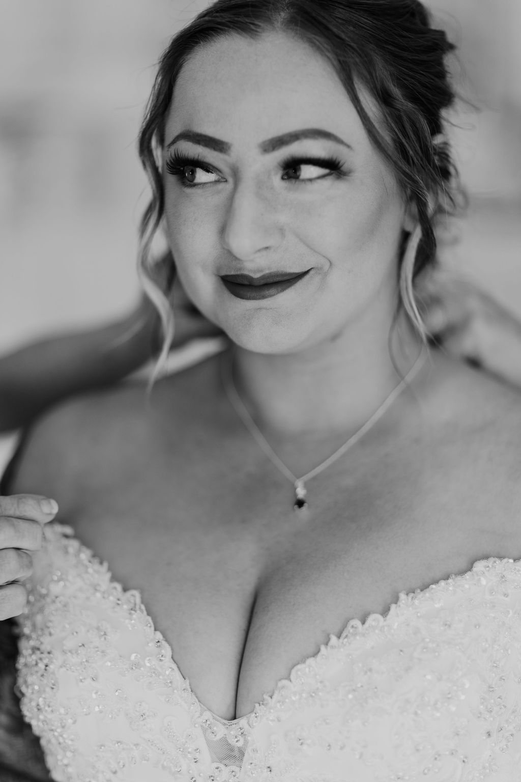 A close-up of the bride smiling while getting ready for the wedding.
