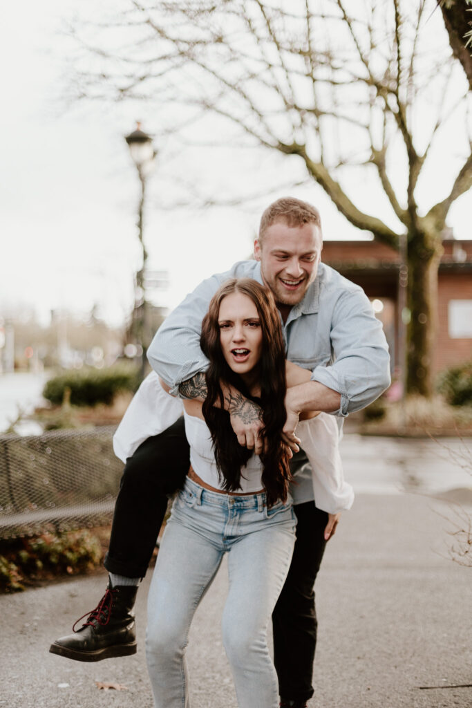 Courtney gives Brandon a piggyback ride, both smiling and playful.