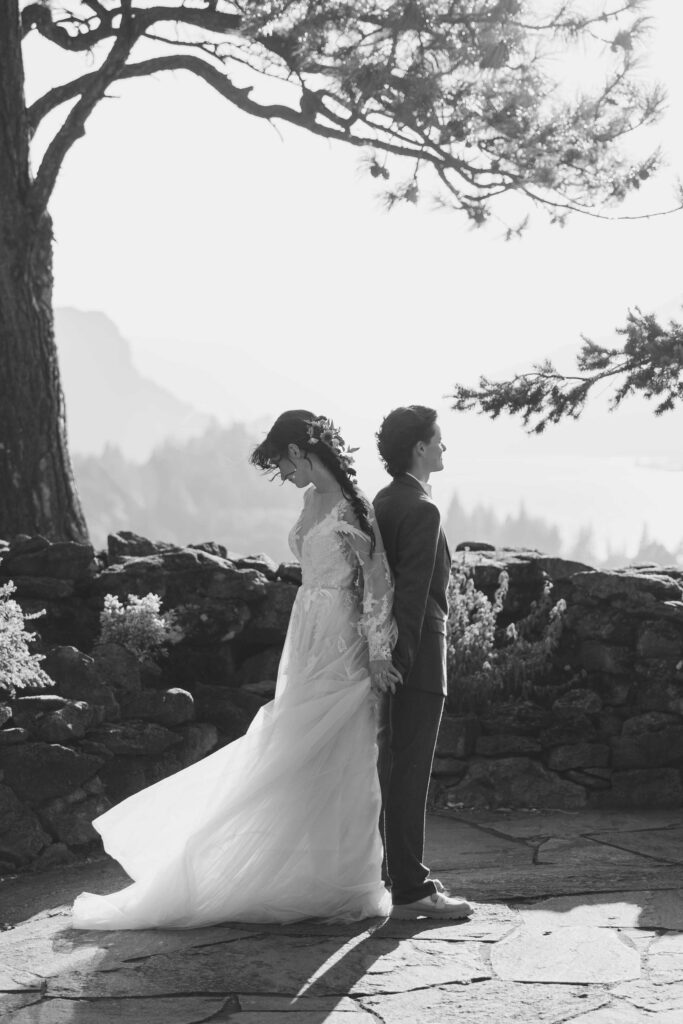 Black and White photo of two LGBT brides in their bridal attire framed by the columbia river gorge at sunset