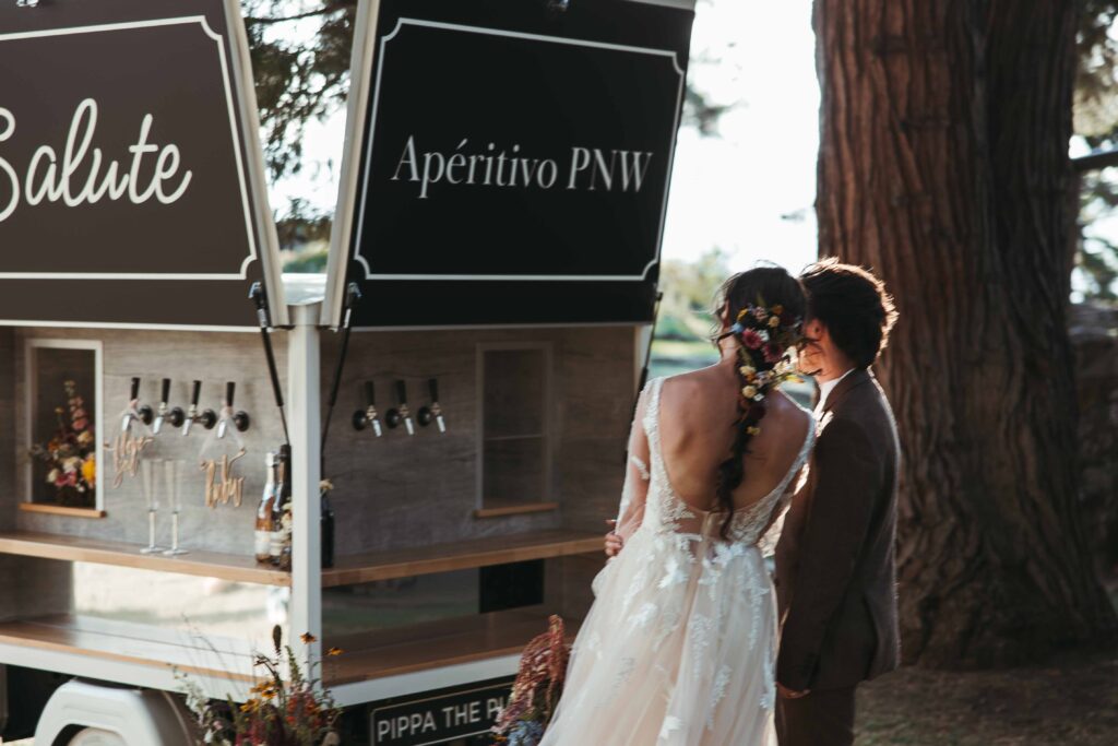 Two brides grabbing a drink before their reception begins in the Columbia River Gorge