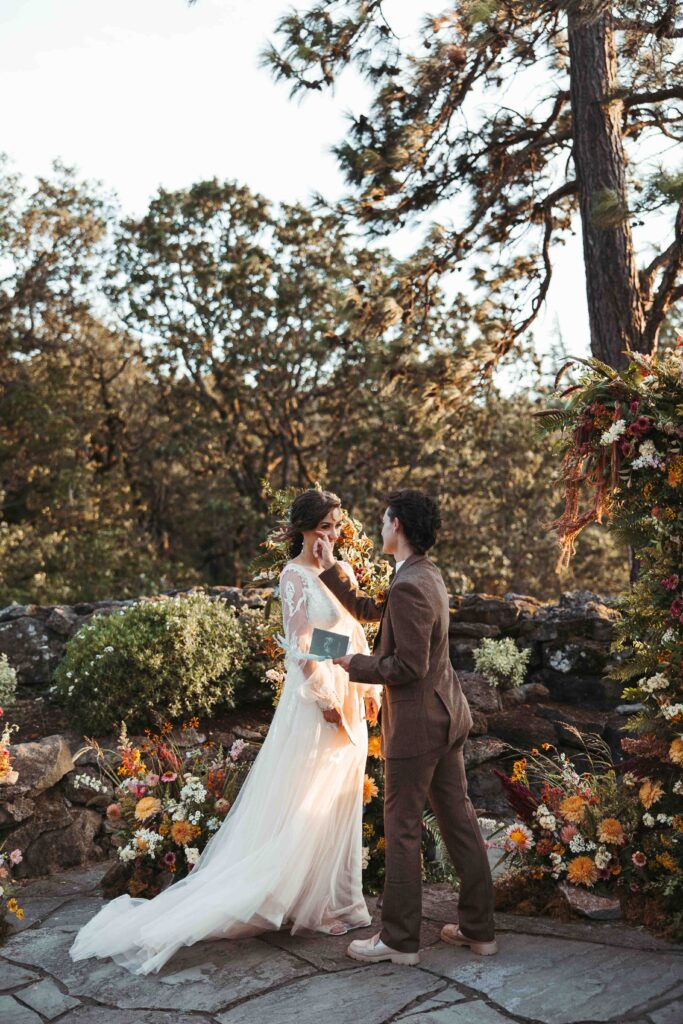 Bride wipes tears away from her partners face during emotional private vow moment