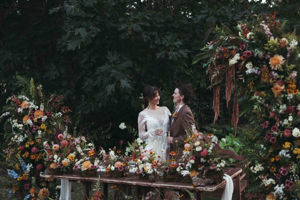two brides celebrate with a toast at their sweetheart table during their reception during their Columbia River Gorge elopement