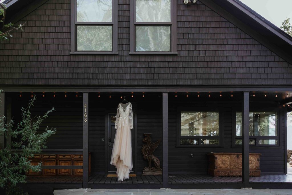 A white dress hanging in front of a modern black cabin in the columbia river gorge in Hood River Oregon