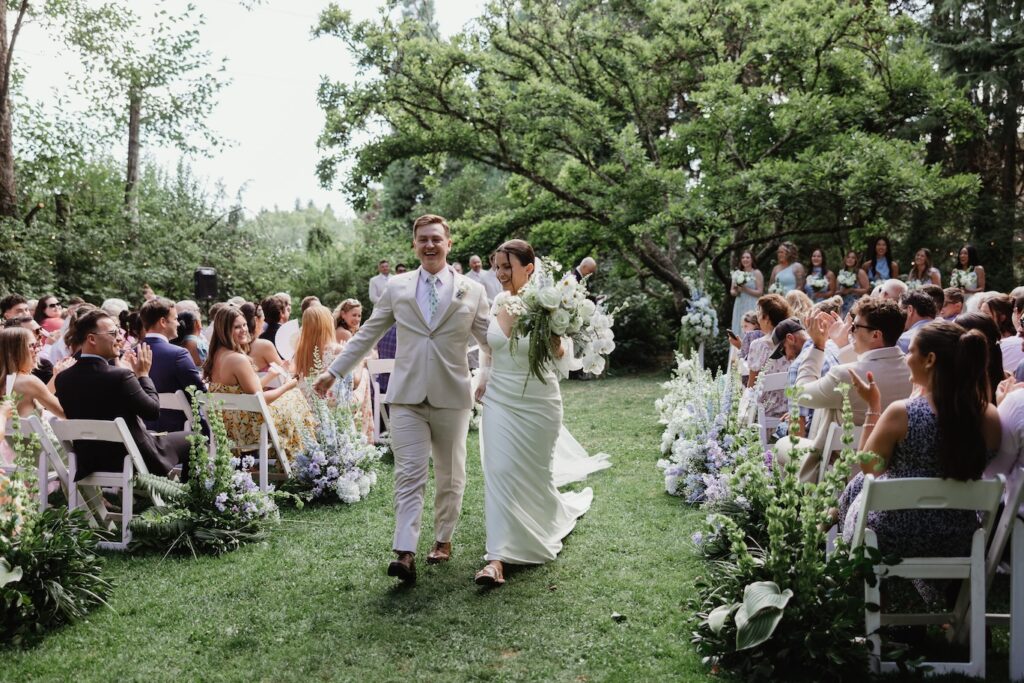 The bride and groom celebrate coming down the isle at Mcmenamins Cornelius Pass Roadhouse