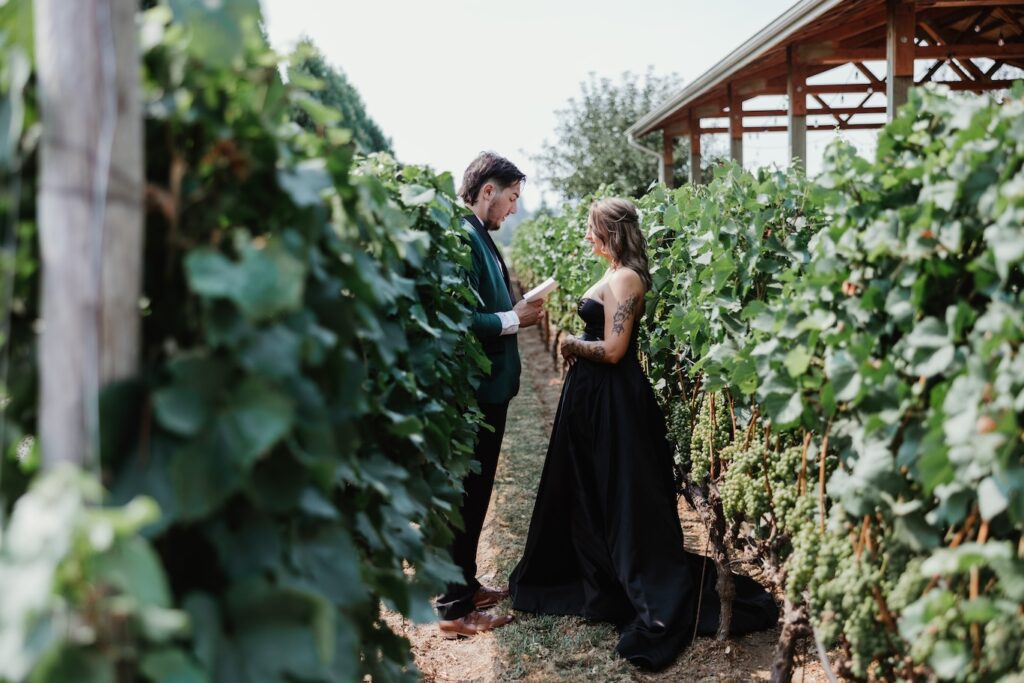 Bride and groom in black attire exchange private vows in a lush vineyard before their wedding ceremony in vancouver wa