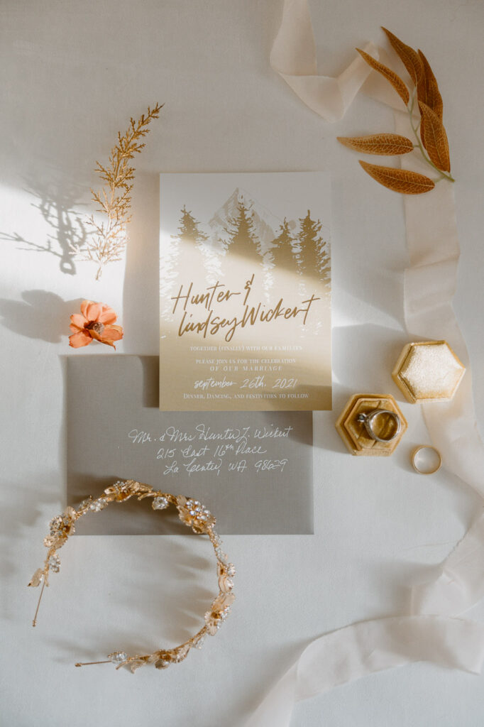 layflat wedding invitation with wedding rings and tiara with wedding florals