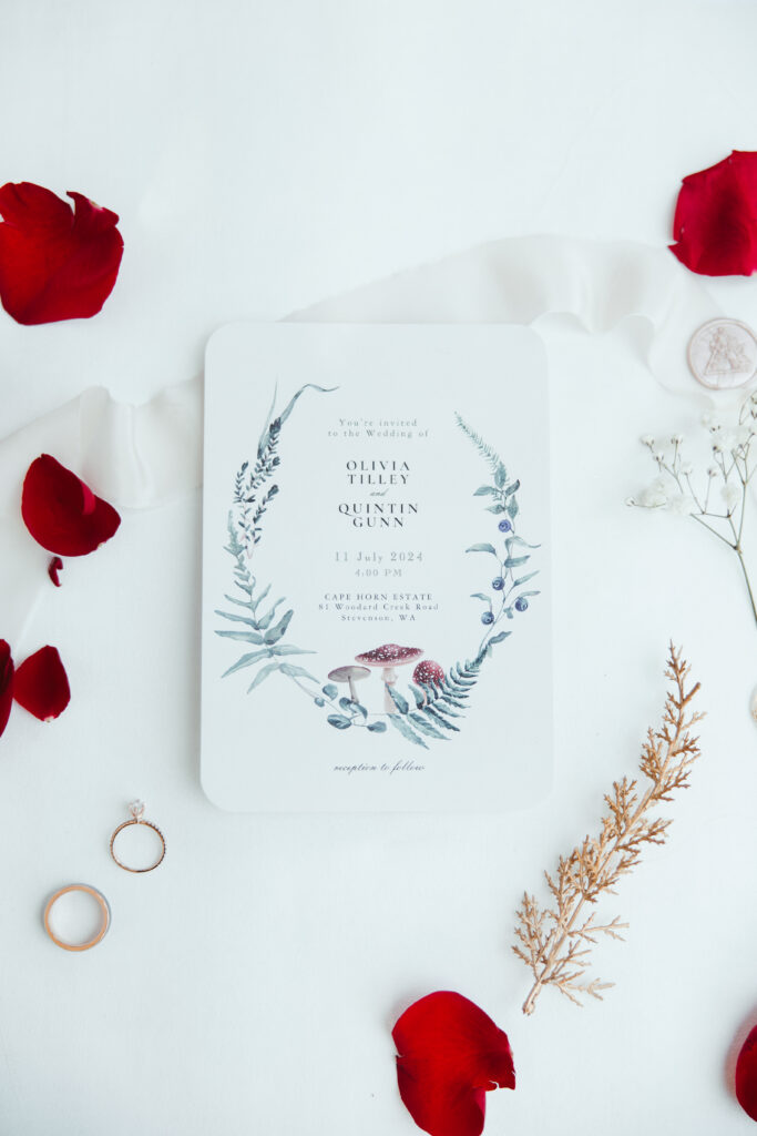 invitation and wedding planning details photographed with rose petals in in Vancouver WA