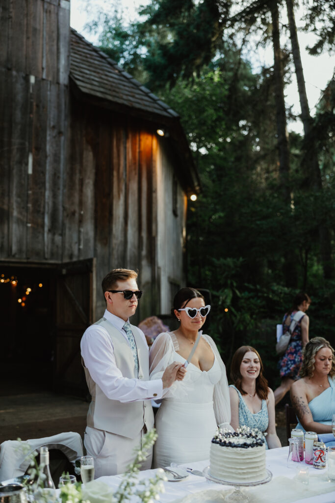 Bride and groom cut their wedding cake during their wedding at Mcmenamins Cornelius Pass Roadhouse