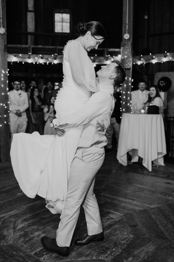 Groom picks up his new bride and spins her around during their wedding in Hillsboro OR