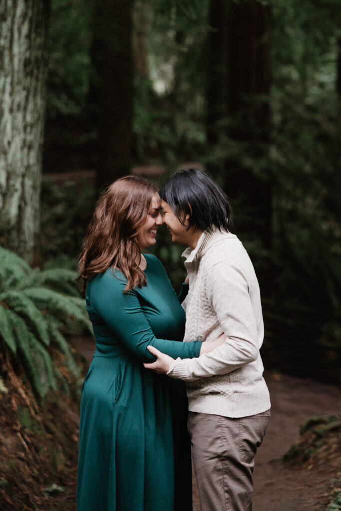 Romantic forehead touch during rainy Portland engagement photos