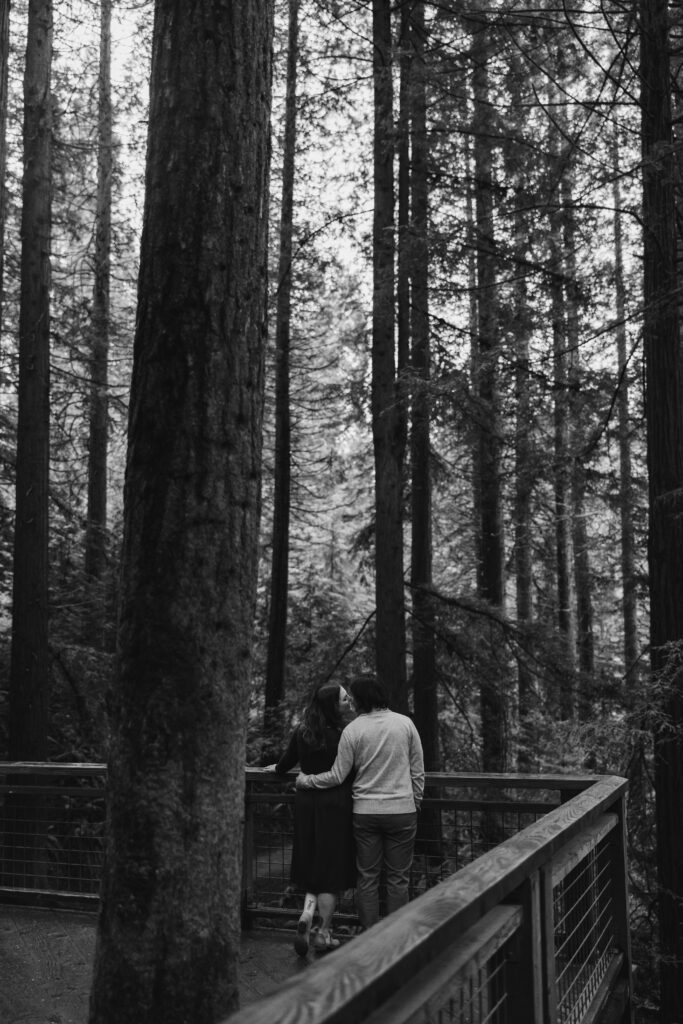 Couple shares a kiss at the Redwood Deck in Hoyt Arboretum
