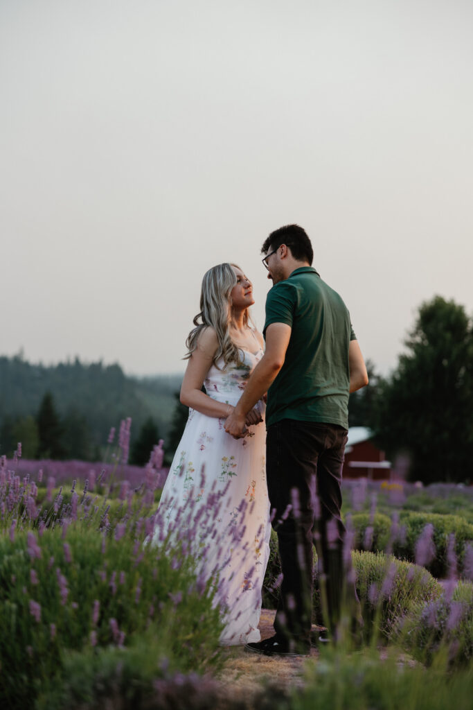 Natural laughing portrait of couple in blooming lavender rows near Hood River Oregon — PNW engagement photographer