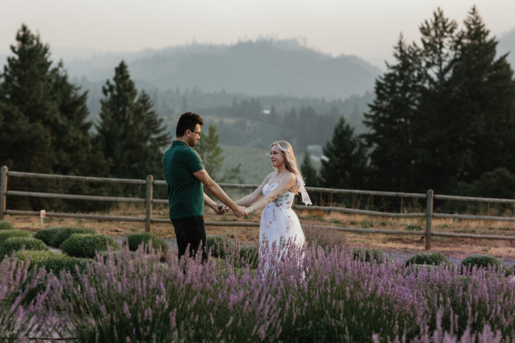 Establishing shot of Hood River Lavender Farms engagement session with hazy summer light and Mt. Hood in the distance — PNW engagement photographer