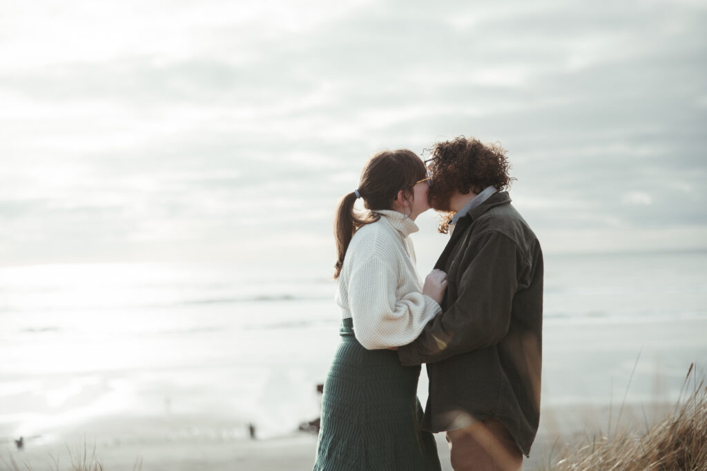 Fort Stevens engagement photographer captures couple with rusted shipwreck hull in background