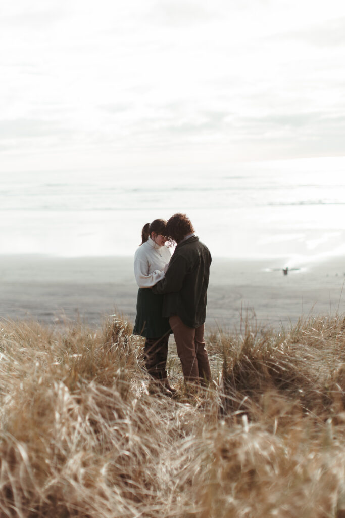 Engaged Couple shares a private moment on the beach at sunset
