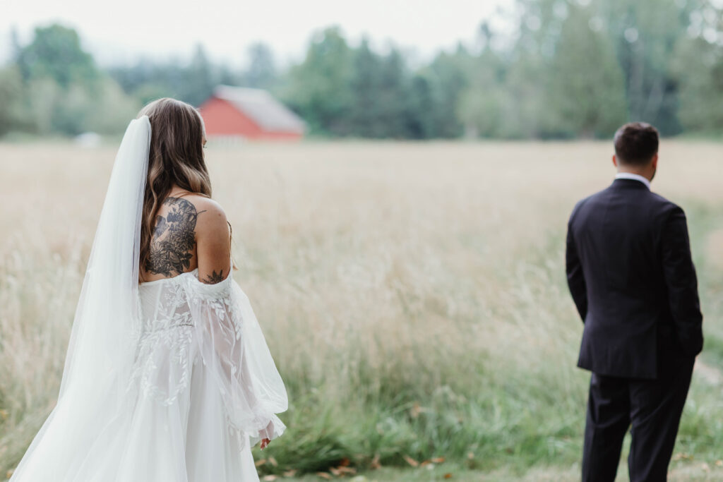 Bride and groom first look in open field at Mount Peak Farm Enumclaw Washington wedding