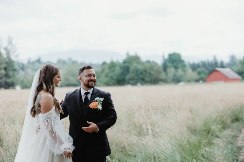 Groom's reaction during first look in open field at Mount Peak Farm Enumclaw Washington