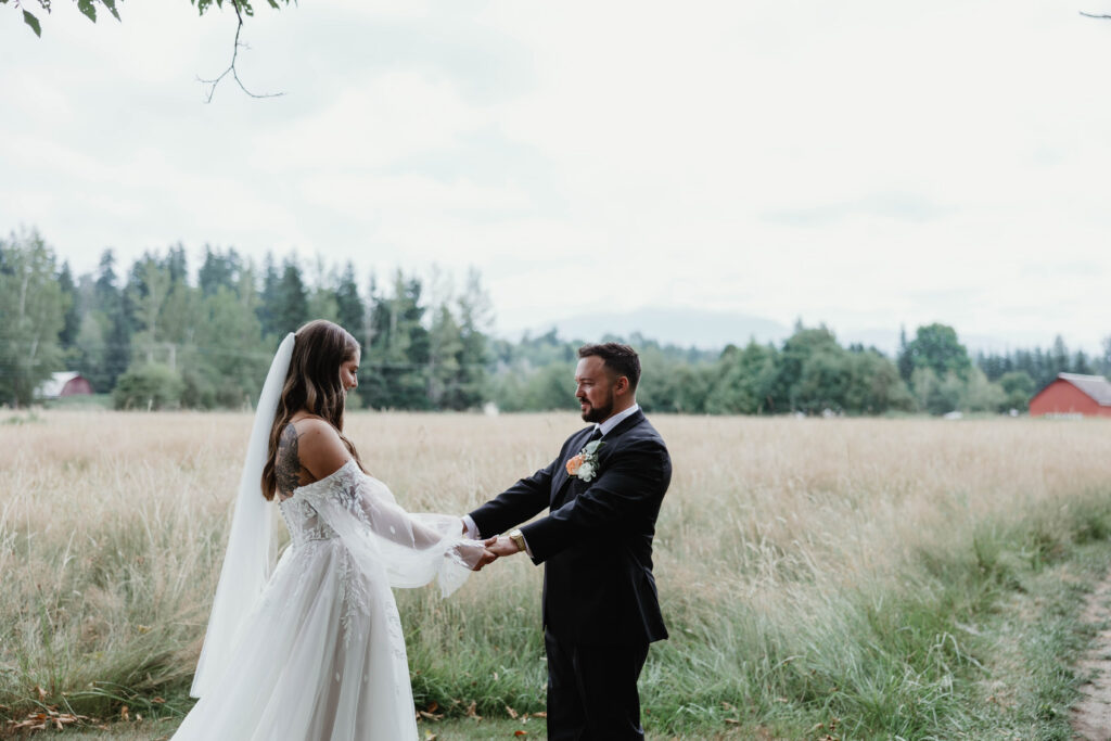 Bride and groom embracing during emotional first look at Mount Peak Farm wedding in Enumclaw Washington