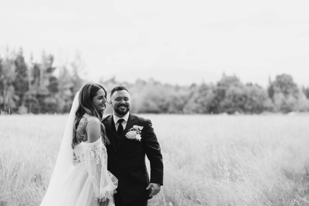 Couple portraits in open field during first look at Mount Peak Farm Enumclaw Washington wedding photographer