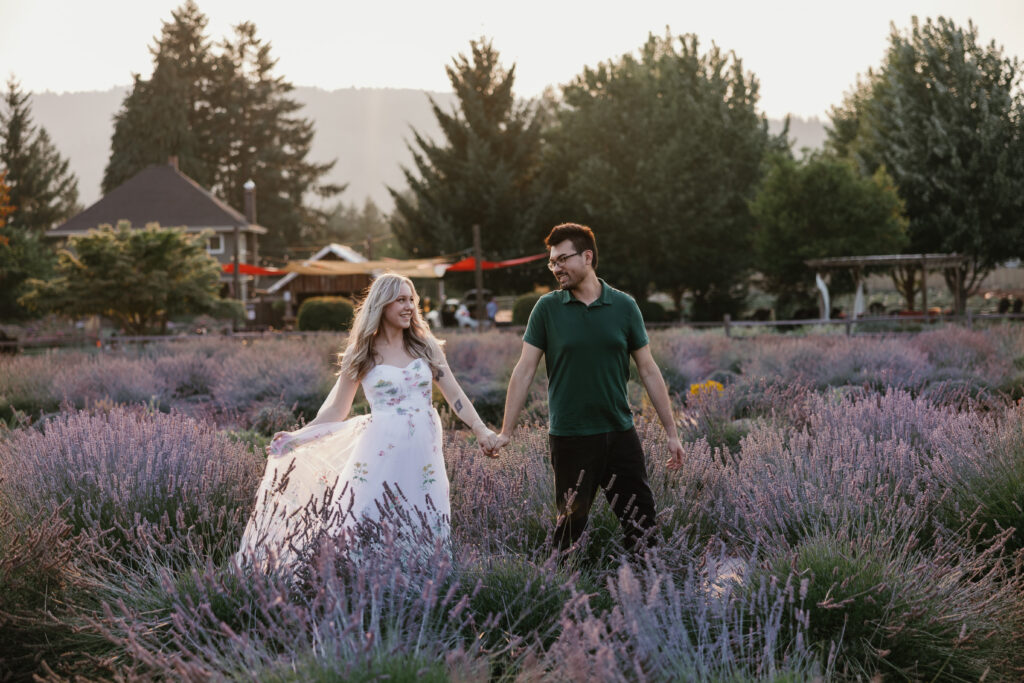 Olivia and Quinton walking hand in hand through lavender rows at Hood River Lavender Farms — Columbia River Gorge engagement photos