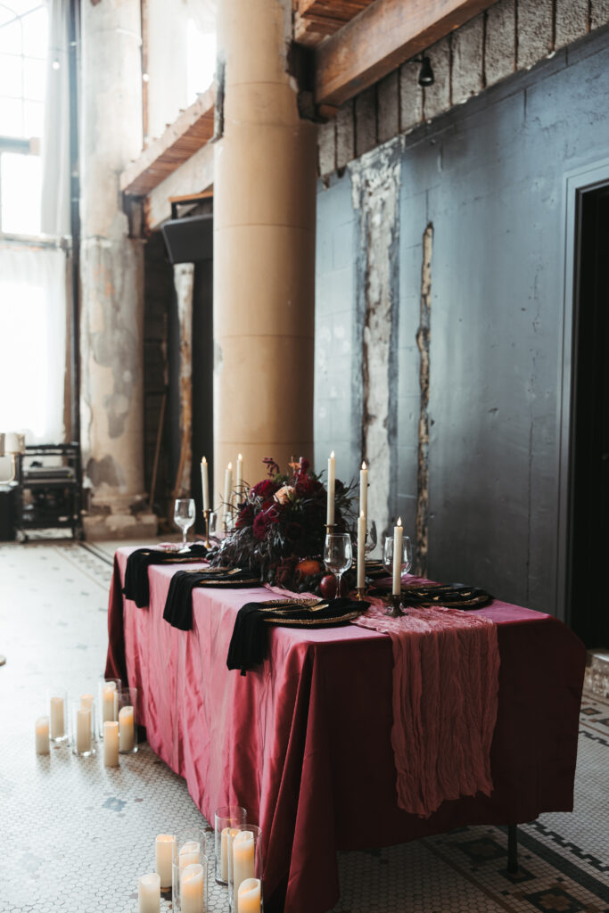 Candlelit reception inside The Ruins at the Astor with exposed plaster walls and arched windows
