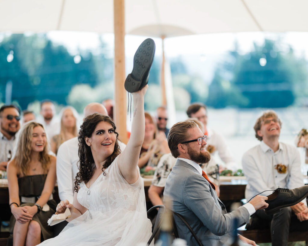 Hunter and Lindsey Wickert laughing together during their wedding ceremony in the Pacific Northwest