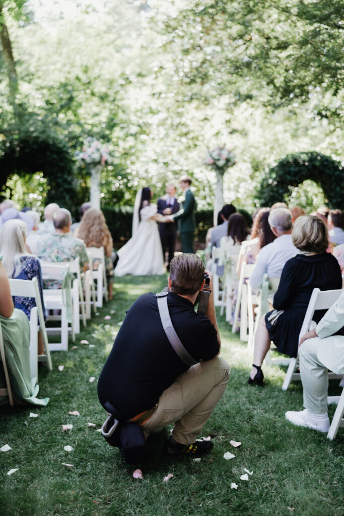 Hunter and Lindsey Wickert photographing a wedding ceremony aisle in Vancouver, Washington