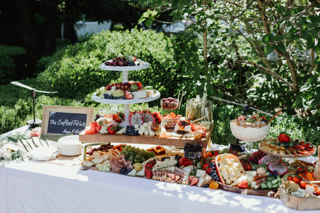 Elegant charcuterie board display at a summer garden wedding reception at Deepwood Museum and Gardens in Salem Oregon