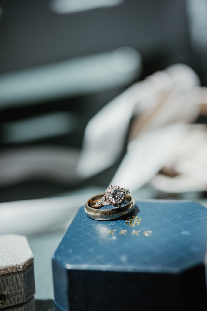 Close-up of wedding rings nestled in summer florals — Deepwood Museum and Gardens wedding details