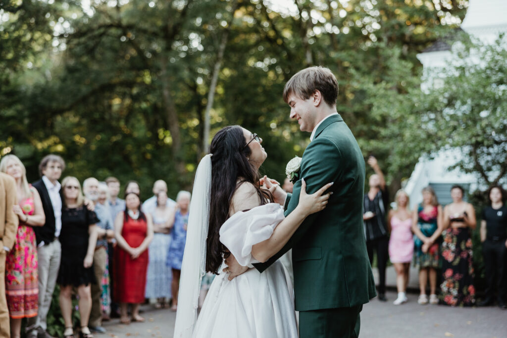 Bride and groom and wedding guests dancing at a summer garden wedding reception at Deepwood Museum and Gardens Salem Oregon