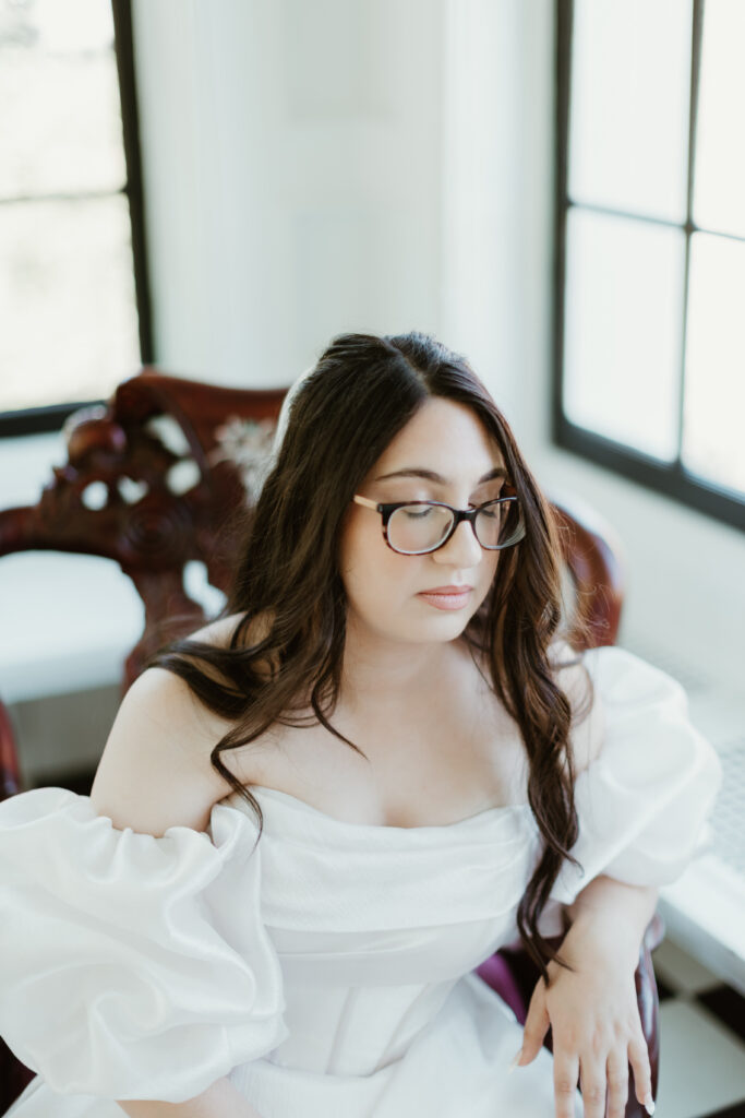 Elegant solo bride sitting in an antique chair at Deepwood Museum and Gardens in Salem OR